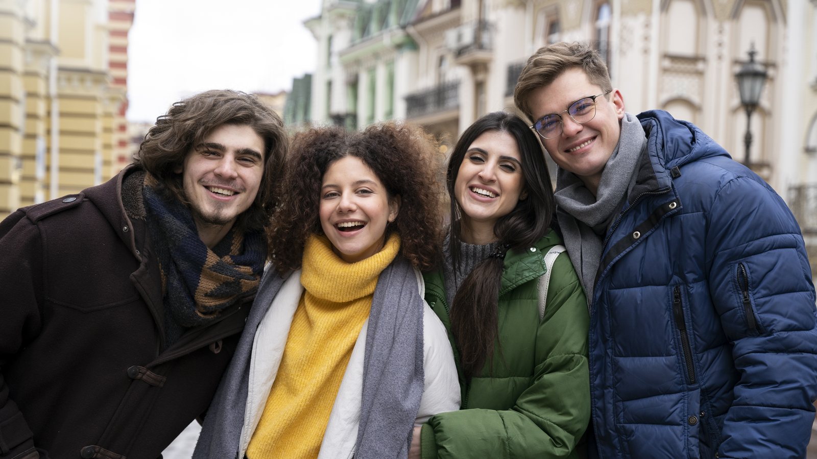 Four friends together on a European city street